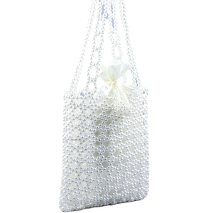 Sac à main fait main en perles tissées avec design creux et sac intérieur en satin