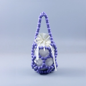 Detail of purple hand-woven beaded bucket bag with white satin drawstring lining