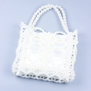 Elegant white handmade pearl woven handbag with a satin drawstring lining pouch