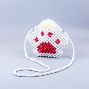 Detail view of handmade cat paw beaded crossbody bag with red and white beads and inner pouch