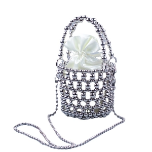 Silver beaded bucket bag with white drawstring pouch and elegant chain shoulder strap