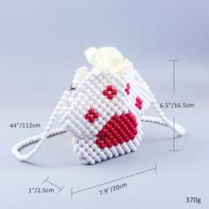 Detail of handmade beaded cat paw crossbody bag with white satin drawstring closure