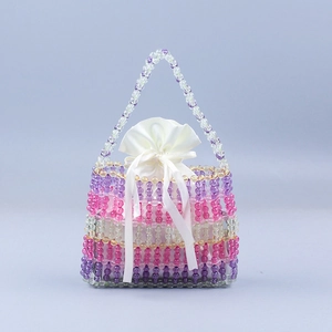 Macro detail of handmade beaded tote with multi-color purple yellow layers and satin pouch