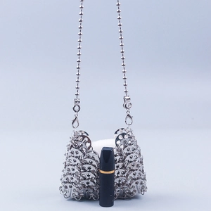Silver metallic sequin crossbody bag with chain strap and modern industrial chic design