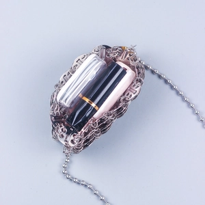 Silver metal sequin woven chain crossbody bag showing capacity for lipstick and small items
