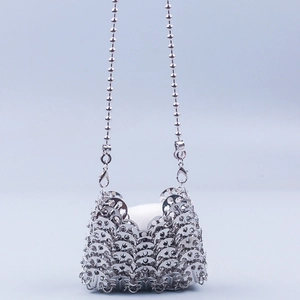 Detail of silver metallic sequin weave texture on a fashion crossbody evening bag
