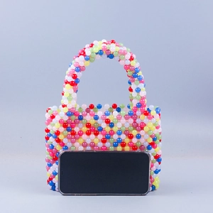 Colorful handmade beaded handbag with rainbow beads and arched handle in minimalist style