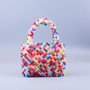 Detail of colorful handmade beaded handbag with vibrant rainbow acrylic beads and woven texture