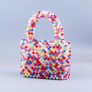 Close-up of handmade rainbow beaded handbag featuring colorful round beads in a woven pattern