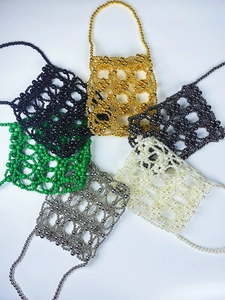 Flat lay of beaded mini handbags in six trendy colors with elegant woven metal textures