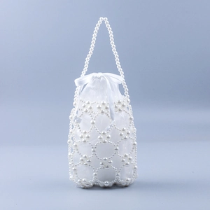 Detailed view of handmade white pearl beaded handbag with translucent drawstring inner bag