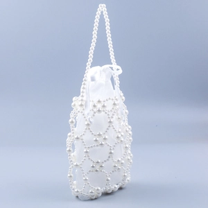 Detail of beaded handbag featuring intricate pearl weaving and white satin drawstring pouch