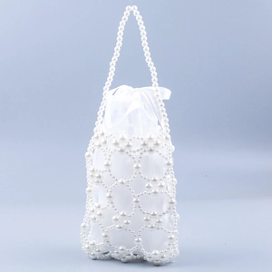 Detail of white pearl beaded handbag showing woven hollow shell and satin drawstring pouch