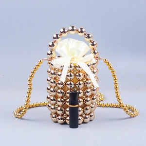 Golden beaded bucket handbag with drawstring lining and crossbody strap