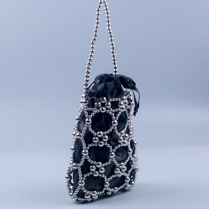 Detailed view of silver beaded bucket bag with black satin lining and drawstring closure