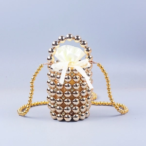 Elegant gold beaded bucket bag with white drawstring liner and woven pearl handle