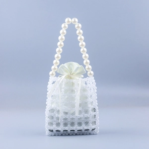 Close-up of pearl handle and hollow-out beaded weave texture with satin inner pouch