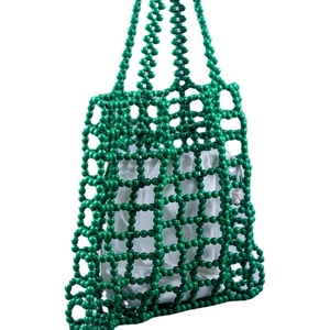 Green beaded tote bag with white drawstring inner pouch and hollow grid design