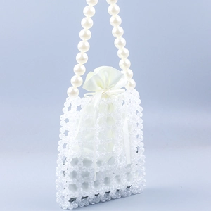 Handmade clear beaded handbag with pearl handle and white satin drawstring pouch inside