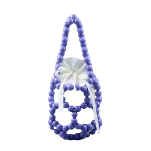 Handmade purple beaded bucket bag with hollow woven design and white satin drawstring pouch