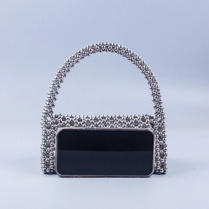 Silver beaded handbag with metal beads shown next to a smartphone for size comparison