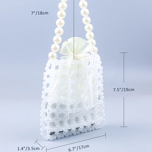 Detail view of woven acrylic beads and faux pearl handles with satin inner pouch