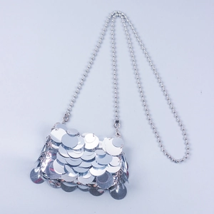 Detail of silver sequin crossbody bag with metallic discs and beaded chain strap