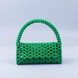 Front view of green handmade beaded tote bag with glossy resin pearls and arched handle