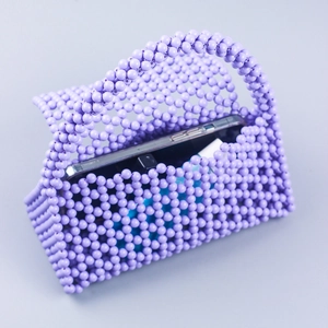 Handmade purple beaded mini handbag featuring decorative woven resin beads and top handle