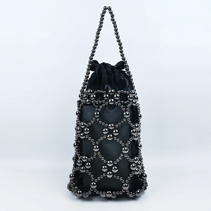 Detail of handmade beaded handbag with gunmetal beads and black satin drawstring bag