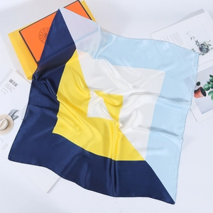 Modern 70cm geometric color block silk scarf displayed with chic accessories