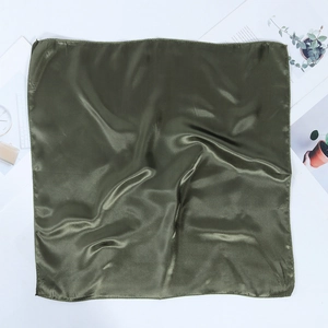 Detail of dark green satin scarf showing smooth texture and metallic luster