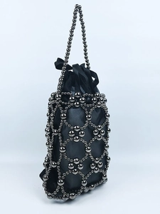 Handmade beaded bucket bag with hollow metal mesh and black silk bow drawstring liner