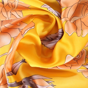 Floral silk scarf with bright yellow patterns and elegant satin drape texture