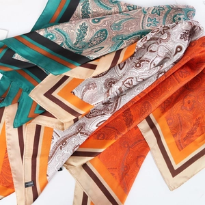 Stack of colorful 70cm paisley silk-feel polyester scarves with striped borders