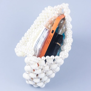 Handmade woven pearl handbag with baroque vintage style showing inner storage space