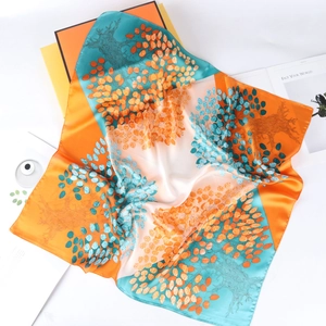Artistic silk square scarf with vibrant orange and teal tree print on white background