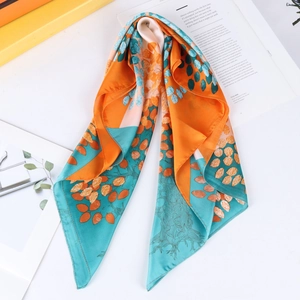 Satin 70cm square scarf featuring orange and green leaf patterns on a flat lay