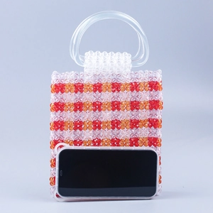 Handmade beaded handbag with red orange geometric pattern and transparent ring handles