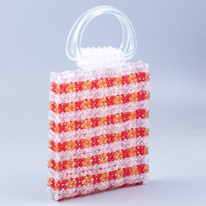 Macro detail of hand-beaded stripe texture on red and orange beaded handbag