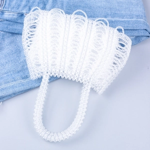 Detailed view of handmade white beaded handbag with irregular wavy weave texture