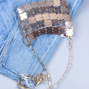 Detailed view of champagne gold square metallic paillettes on a trendy crossbody bag