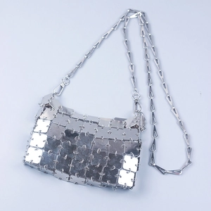 Detailed close-up of a silver metallic chainmail bag with mirror square sequins