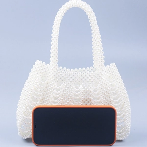 Handmade white pearl beaded tote bag with a woven wave pattern and top handle design