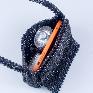 Black acrylic beaded handbag for women featuring a U-shaped handle and woven texture