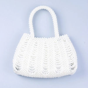 Detail of handmade woven pearl handbag with irregular wave texture and white glossy finish