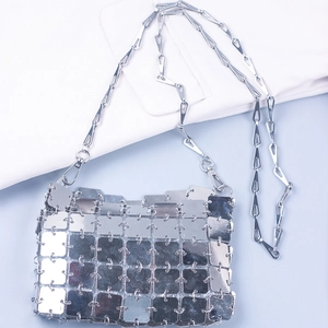 Detailed close-up of metallic silver sequin crossbody bag with square chain links