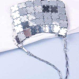 Detailed close-up of square silver metallic sequins connected by rings on a futuristic bag