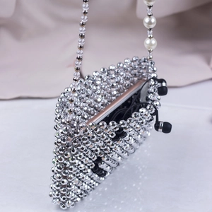 Silver beaded crossbody phone bag with pearl strap showing smartphone inside capacity