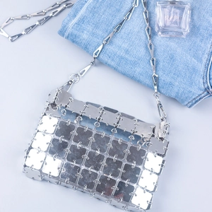 Detailed view of silver sequin crossbody bag with chain and metallic woven square panels